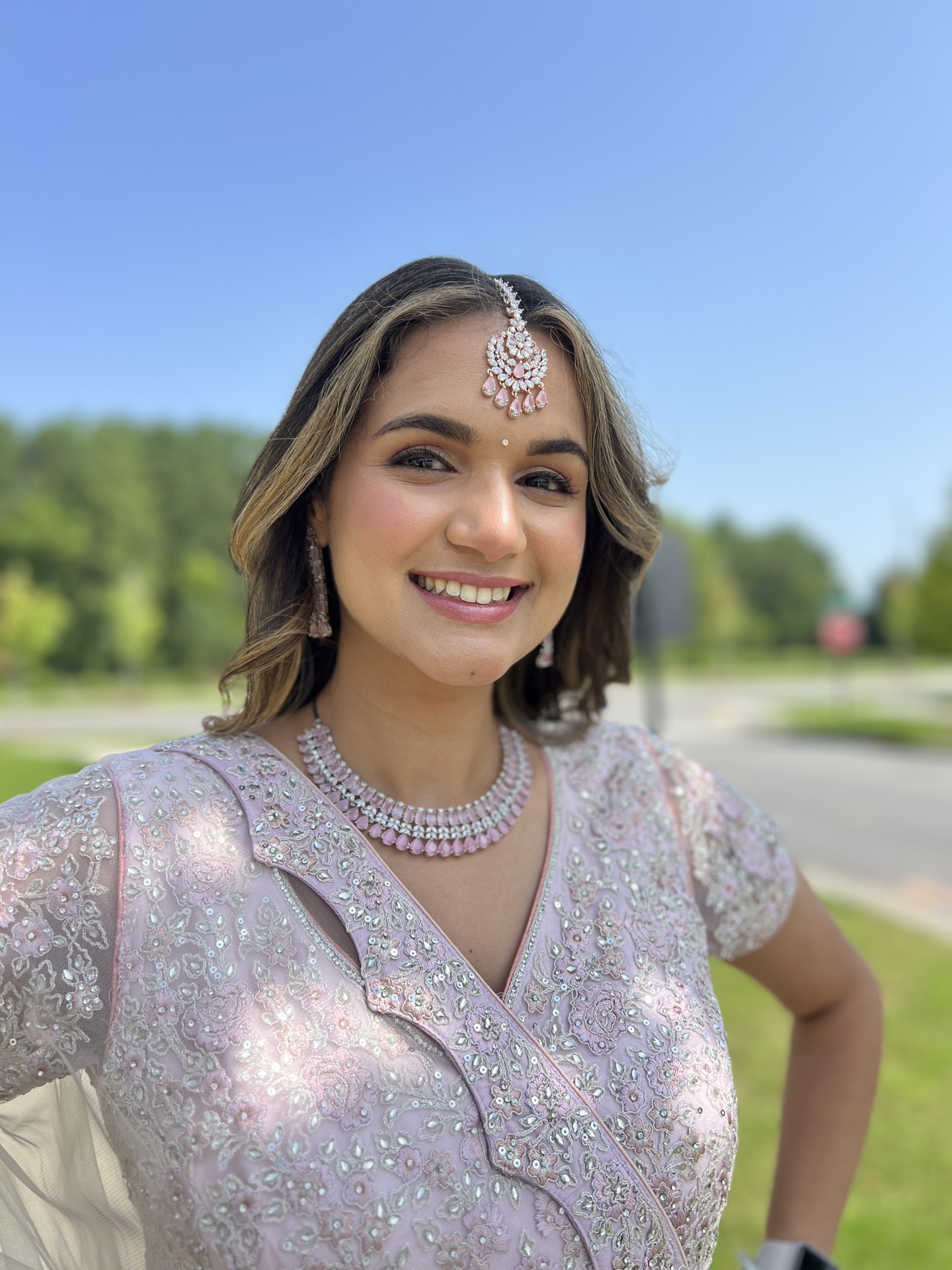 Indian wedding hairstyle with floral bridal bun by Ritu Patel