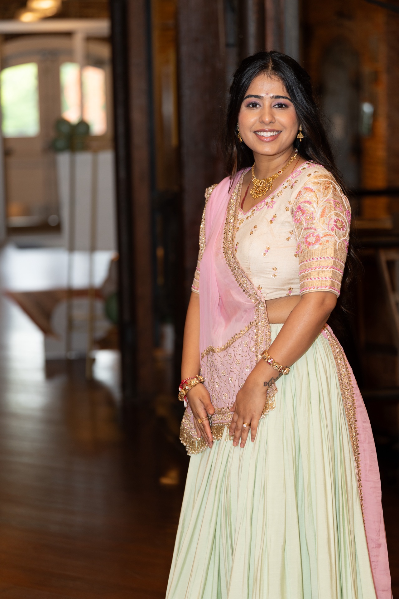 Soft glam makeup and pastel green lehenga with pink dupatta styling for South Asian wedding guest in Raleigh NC