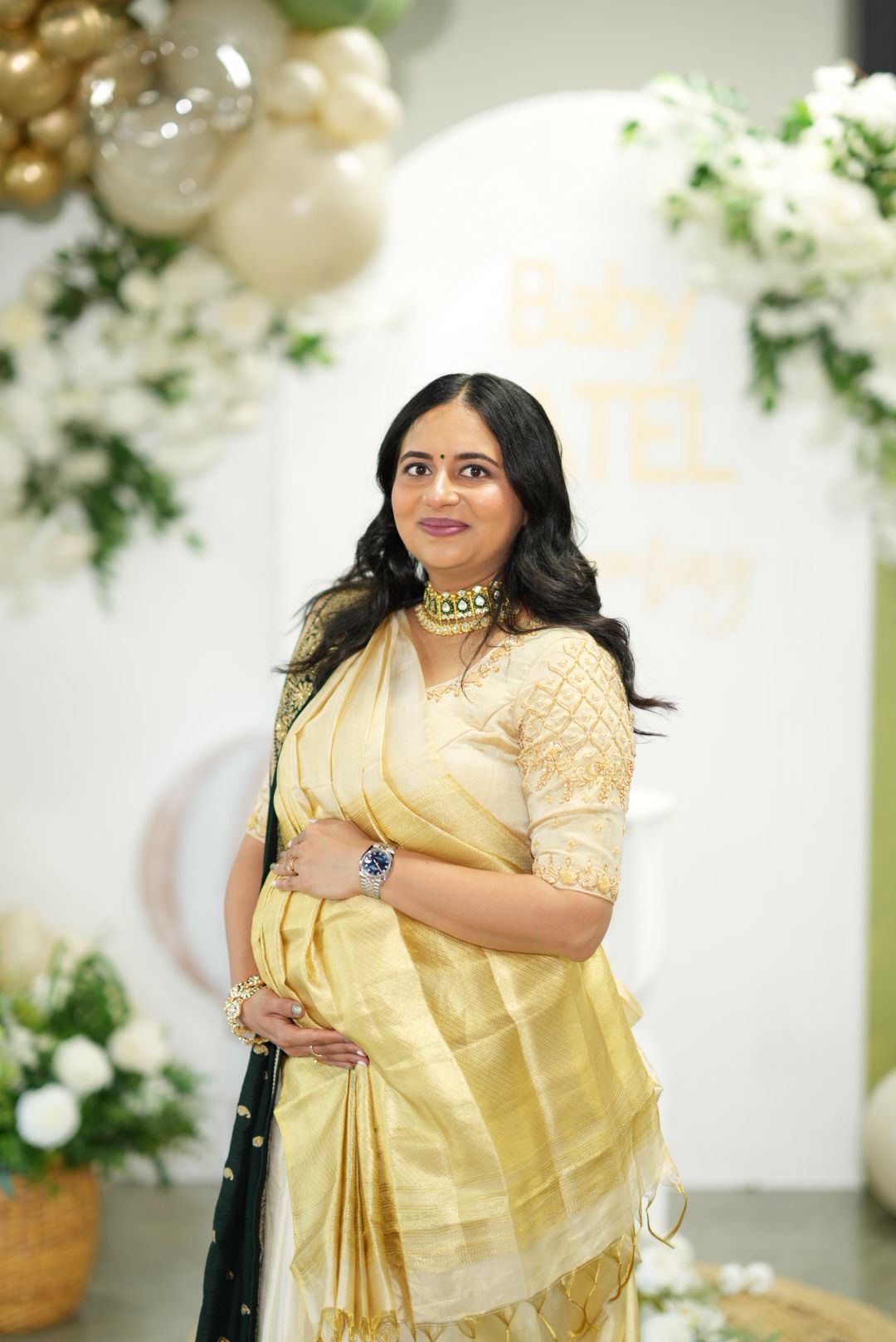 Baby shower saree draping in cream and gold tissue saree with kundan choker by Ritu Patel