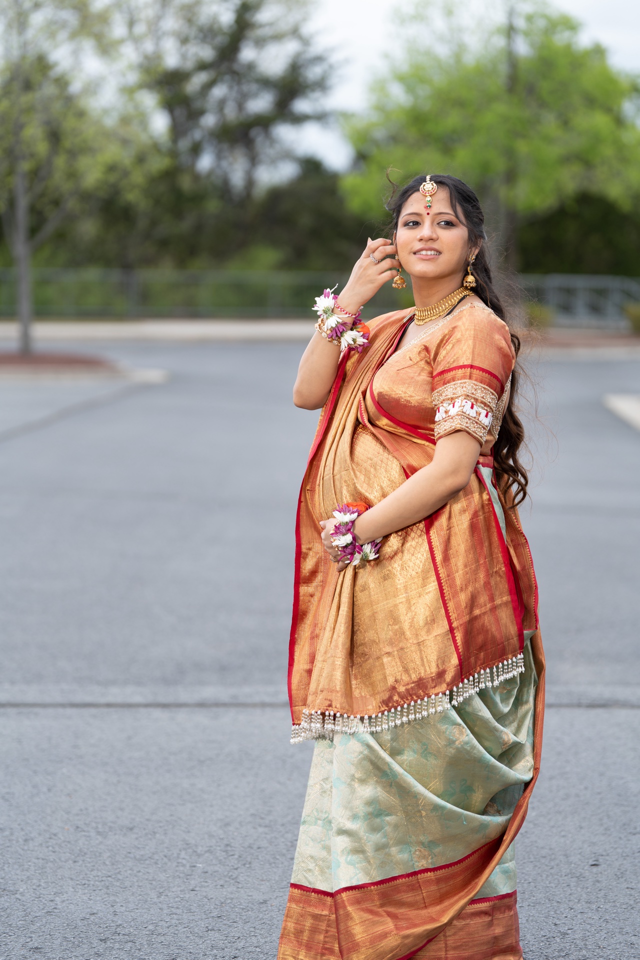 Seemantham baby shower styling in orange Kanjeevaram silk saree with traditional South Indian draping